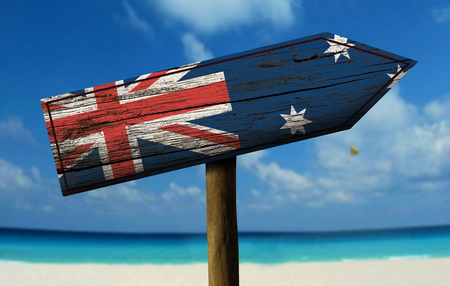 Australia flag wooden sign with a beach on background - Oceania